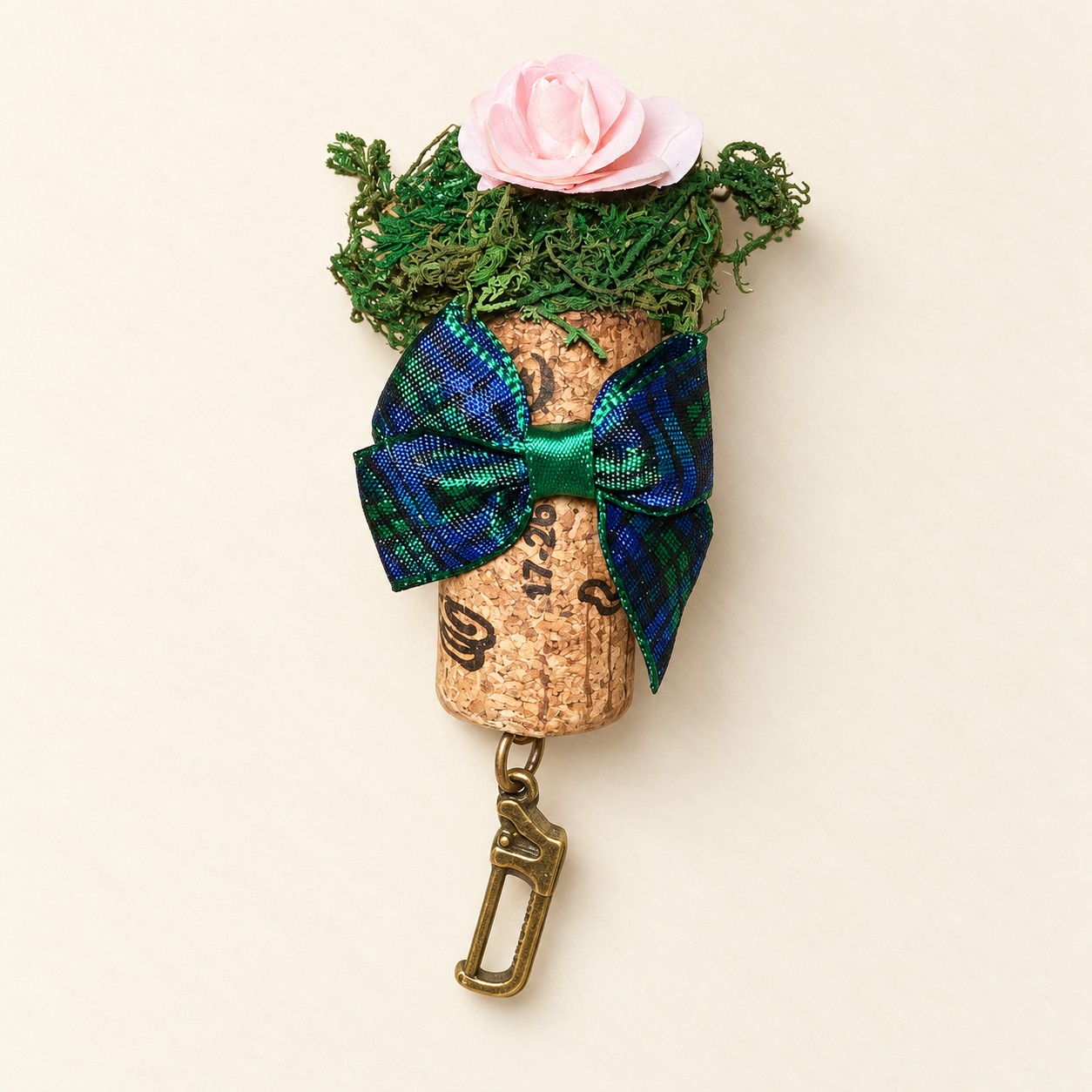 Illustrative mockup of a pink rose cork magnet with tartan bow and saw charm